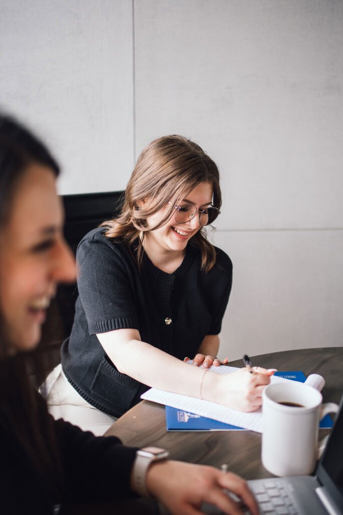 A women taking notes in a meeting room