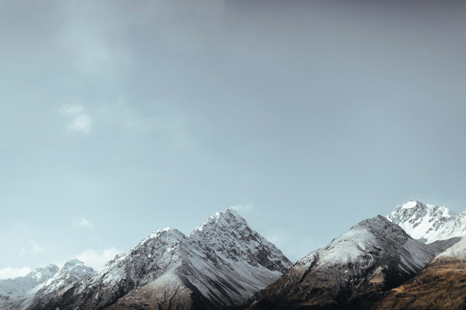 Snow capped mountains infront of a blue sky